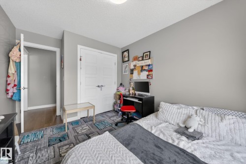 Neutral gray walls complement the textured white ceiling - 3639 15A Street, Edmonton, AB - Indoor Photo Showing Bedroom