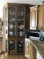 Custom built-in display cabinetry featuring glass-front doors and wood-finish construction - 