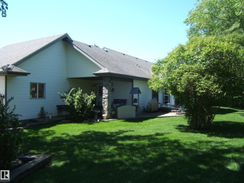 Expansive green lawn with mature trees providing shade - 123064 Hwy 45, Rural Two Hills County, AB 