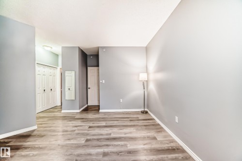 Unfurnished room with light wood-style flooring and baseboards - 507 11716 100 Avenue, Edmonton, AB - Indoor Photo Showing Other Room
