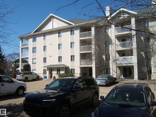 Multi-story building featuring light-colored siding and multiple private balconies with white railings - 105 11214 80 Street, Edmonton, AB - Outdoor