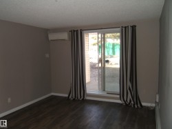 Interior space featuring wood-finish flooring and neutral wall tones - 