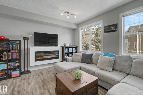 85 2803 James Mowatt Trail, Edmonton, AB - Indoor Photo Showing Living Room With Fireplace