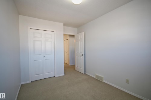 Neutral-toned carpeting paired with light gray walls - 11 230 Edwards Drive, Edmonton, AB - Indoor Photo Showing Other Room