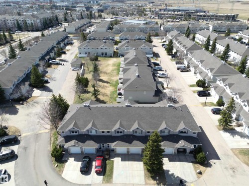Aerial perspective showcasing a residential community with multiple townhouse complexes - 11 230 Edwards Drive, Edmonton, AB - Outdoor With View