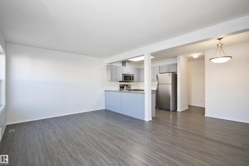 Open-concept living area with wood-finish flooring - 11 230 Edwards Drive, Edmonton, AB - Indoor Photo Showing Kitchen