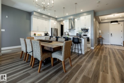 Open-concept living space with wood-finish flooring - 108 7463 May Common, Edmonton, AB - Indoor Photo Showing Dining Room