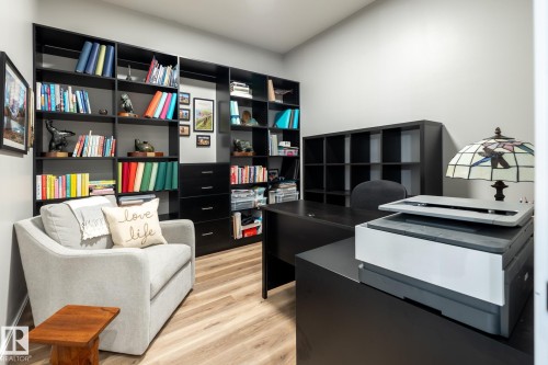 Integrated black shelving and cabinetry system with wood-finish flooring - 108 7463 May Common, Edmonton, AB - Indoor