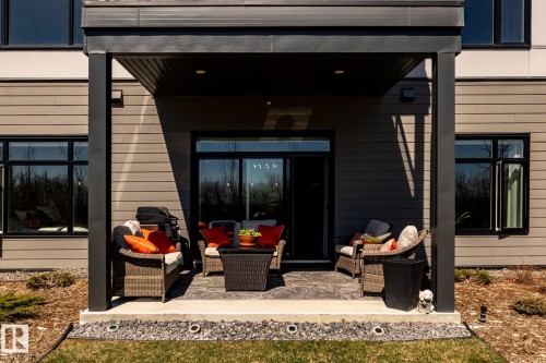 Covered patio featuring a concrete slab and overhead lighting - 108 7463 May Common, Edmonton, AB - Outdoor With Deck Patio Veranda With Exterior