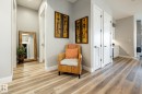 Hallway featuring wood-finish flooring, light grey wall paint, and white trim - 108 7463 May Common, Edmonton, AB  - Indoor Photo Showing Other Room 