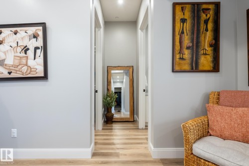 Hallway featuring light wood-finish flooring, white baseboards, and recessed ceiling lighting - 108 7463 May Common, Edmonton, AB - Indoor Photo Showing Other Room