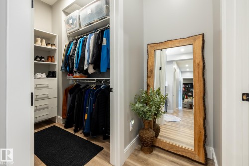 Organized closet system featuring shelving, drawers, and hanging rods - 108 7463 May Common, Edmonton, AB - Indoor
