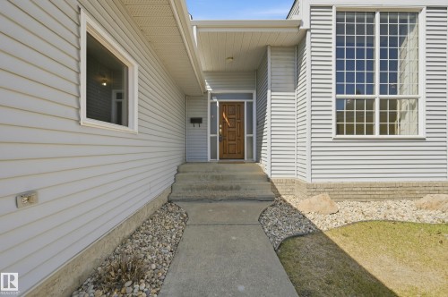 Light gray horizontal siding exterior with a prominent multi-pane window feature - 394 Walker Road, Edmonton, AB - Outdoor