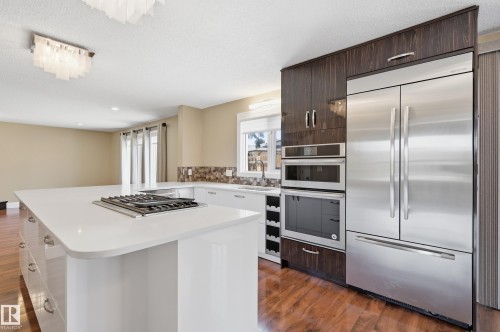 Kitchen featuring a large central island with a built-in gas cooktop, white countertop, and integrated storage - 394 Walker Road, Edmonton, AB - Indoor Photo Showing Kitchen With Stainless Steel Kitchen With Upgraded Kitchen