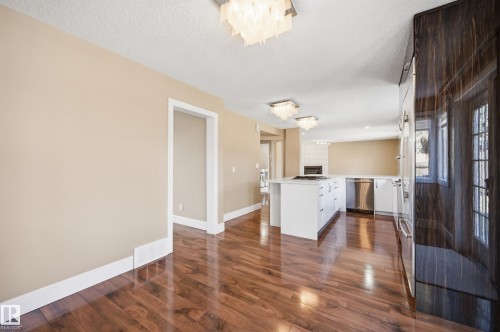 Expansive interior featuring wood-finish flooring, neutral-toned walls, and white baseboards - 394 Walker Road, Edmonton, AB - Indoor