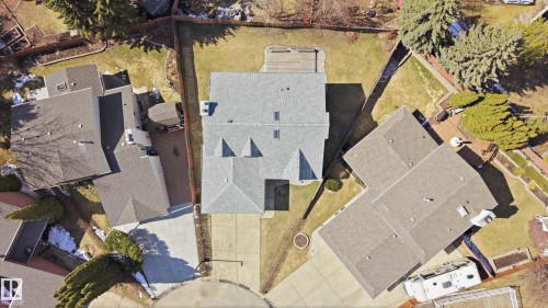 Aerial view showcasing a property with a shingled roof, skylights, an attached garage, a paved driveway, and a backyard featuring a wooden deck and fencing - 394 Walker Road, Edmonton, AB -  With View