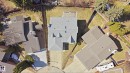 Aerial view showcasing a property with a shingled roof, skylights, an attached garage, a paved driveway, and a backyard featuring a wooden deck and fencing - 394 Walker Road, Edmonton, AB  -  With View 