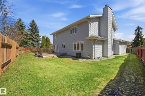 Spacious backyard featuring a wooden privacy fence and a ground-level deck - 394 Walker Road, Edmonton, AB - Outdoor With Backyard