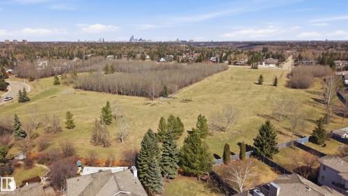Expansive green space featuring scattered mature trees and distant urban skyline - 394 Walker Road, Edmonton, AB - Outdoor With View