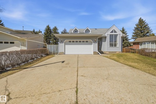Light gray siding exterior with a prominent vaulted window feature - 394 Walker Road, Edmonton, AB - Outdoor