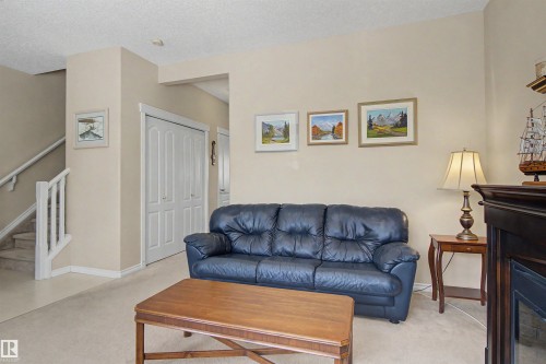 56 1780 Glastonbury Blvd, Edmonton, AB - Indoor Photo Showing Living Room With Fireplace