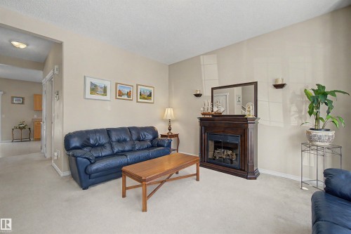 56 1780 Glastonbury Blvd, Edmonton, AB - Indoor Photo Showing Living Room With Fireplace