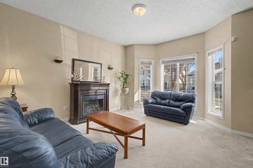 56 1780 Glastonbury Blvd, Edmonton, AB - Indoor Photo Showing Living Room With Fireplace