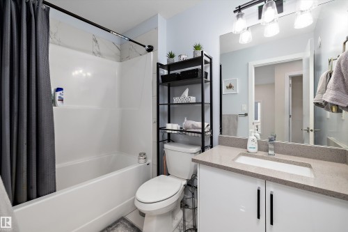 Bathroom featuring a white tub and shower combination with a large format tile surround - 82 Wingate Way, Fort Saskatchewan, AB - Indoor Photo Showing Bathroom