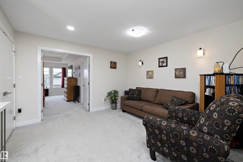 Carpeted room with recessed lighting and wall sconces - 82 Wingate Way, Fort Saskatchewan, AB - Indoor Photo Showing Living Room