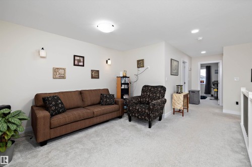 Neutral-toned walls complement the light gray carpet flooring - 82 Wingate Way, Fort Saskatchewan, AB - Indoor Photo Showing Living Room