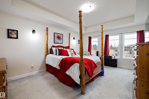 Spacious room featuring light-colored walls and grey carpeting - 82 Wingate Way, Fort Saskatchewan, AB - Indoor Photo Showing Bedroom