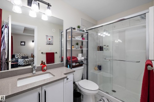 Contemporary bathroom featuring a spacious vanity with an undermount sink and a speckled countertop - 82 Wingate Way, Fort Saskatchewan, AB - Indoor Photo Showing Bathroom