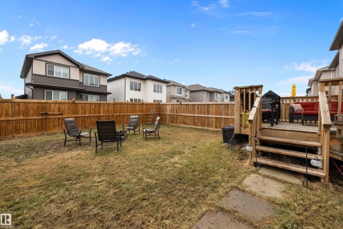 Fenced backyard featuring a wood deck with stairs, a grass area, and a privacy fence - 82 Wingate Way, Fort Saskatchewan, AB - Outdoor