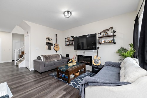 Living area featuring dark wood-finish flooring and light wall paint - 84 Wingate Way, Fort Saskatchewan, AB 