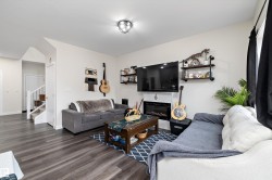 Living area featuring dark wood-finish flooring and light wall paint - 