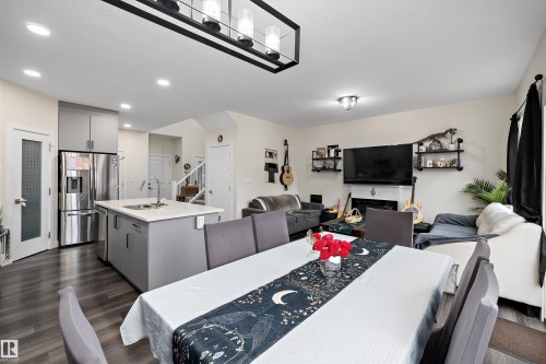 Open-concept main living area with wood-finish flooring - 84 Wingate Way, Fort Saskatchewan, AB 