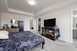 Neutral wall colors, recessed ceiling feature, and light-toned carpet flooring - 