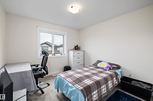 Neutral wall paint, light-colored carpeting, and a window with white trim - 84 Wingate Way, Fort Saskatchewan, AB 