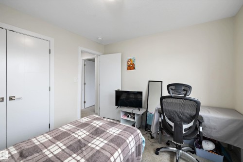 Neutral-toned room featuring a single door opening, a pair of bi-fold doors, and recessed ceiling lighting - 84 Wingate Way, Fort Saskatchewan, AB 