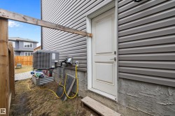 Gray horizontal vinyl siding with a white panel door - 