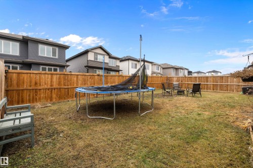 Fenced backyard with ample green space - 84 Wingate Way, Fort Saskatchewan, AB 