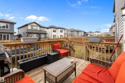 Spacious wooden deck with railing, offering multiple levels and steps down to the backyard - 