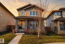 Two-story home with a covered front porch featuring stone-clad pillars and a wood-paneled exterior - 1148 35 Avenue, Edmonton, AB  - Outdoor With Deck Patio Veranda 