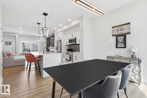 Open-concept kitchen and dining area with wood-finish flooring - 61 230 Edgemont Road, Edmonton, AB - Indoor