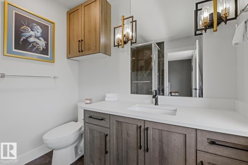 Bathroom vanity featuring a white countertop with an integrated rectangular sink - 61 230 Edgemont Road, Edmonton, AB - Indoor Photo Showing Bathroom