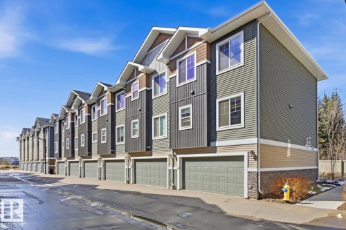 Modern townhome exterior featuring multi-toned siding, white trim, and a two-car garage - 61 230 Edgemont Road, Edmonton, AB - Outdoor With Facade