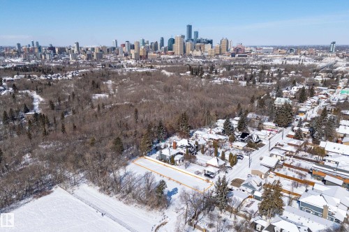 Aerial view showcasing the property's location within a residential area, featuring a distant city skyline - 9209 96 Street Nw, Edmonton, AB 