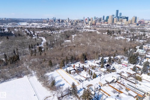 Aerial view of the property and its surrounding area, featuring a distant city skyline with high-rise buildings - 9209 96 Street Nw, Edmonton, AB 