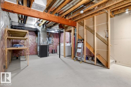 Spacious unfinished basement featuring exposed wood joists, concrete flooring, and visible ductwork - 18 6032 38 Avenue, Edmonton, AB - Indoor Photo Showing Basement