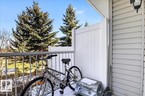 Outdoor balcony featuring a white privacy screen and horizontal siding - 18 6032 38 Avenue, Edmonton, AB - Outdoor With Exterior